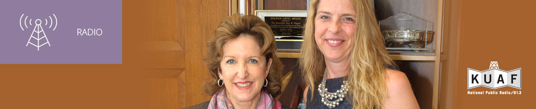 Photo of Kay Hagan and Jennifer Platt with KUAF logo and white sans-serif type in upper left on muted lavender background with radio icon