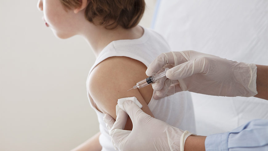 Little boy getting a shot by a doctor