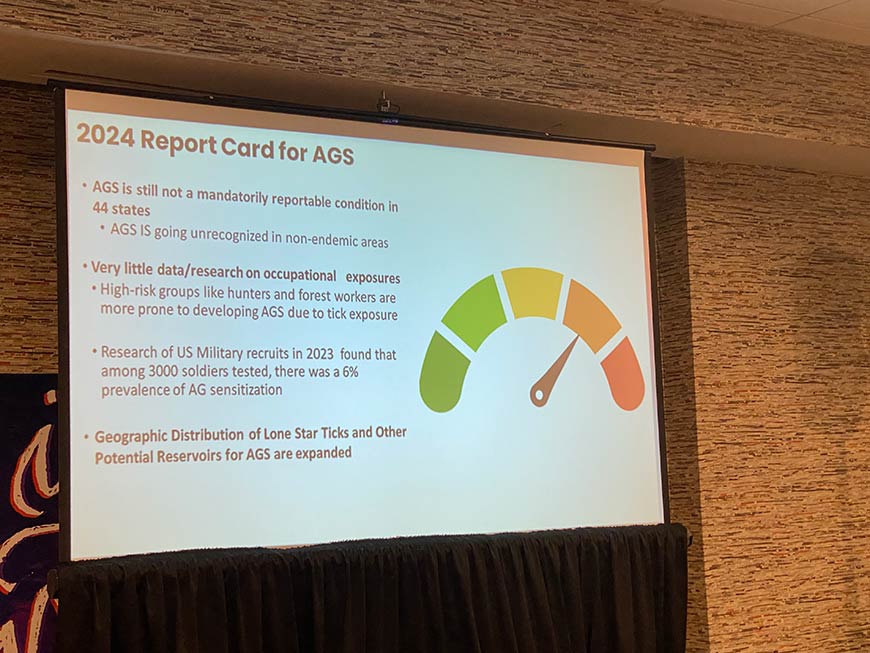 Photo of 2024 report card for AGS presentation on a screen